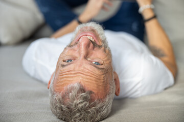 Happy face of a man on a sofa
