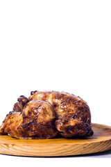 Roast chicken on a wooden tray on white background