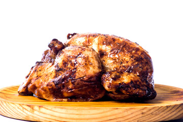 Roast chicken on a wooden tray on white background