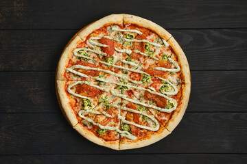 Top view of pizza with mozzarella, tomato, spinsch and mayonnaise