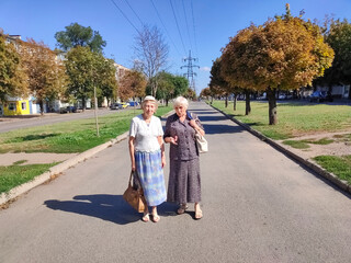 Two senior ladies going on the city strret