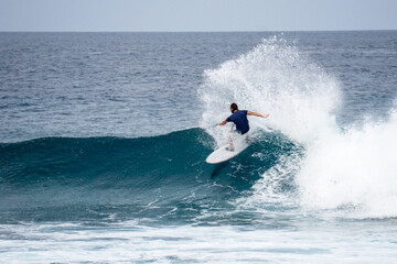 Surfer on perfect blue aquamarine wave, empty line up, perfect for surfing, clean water, Indian Ocean