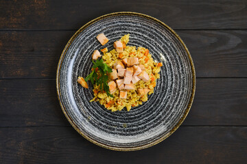 Top view of plate with risotto with ham and carrot
