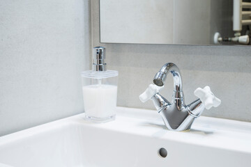 bathroom sink with mirror and soap