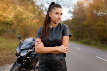 Fototapeta na wymiar Portrait of female motorcyclist on the road