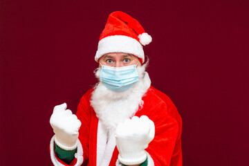 angry santa claus clenched fists face medical mask, tired of new year and christmas.Close up
