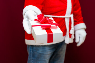 Cropped view of santa claus holding gift box.Front view Close up