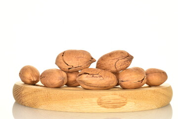 Several ripe unpeeled pecans, close-up, isolated on white.