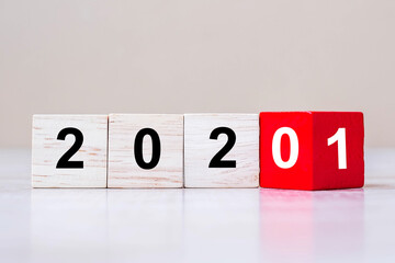wooden cube blocks with 2020 change to 2021 number text on table background. New Year Resolution, strategy, plan, start, goal, business and holiday concepts