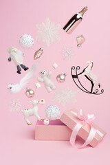 Opened traditional Christmas gift box explosion with flying Santa, champagne, deer and ornaments on...