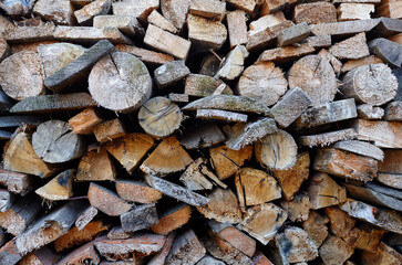 Wooden logs,boards, firewood. Harvesting firewood for the winter. Lumber for furniture making. Texture of wooden materials
