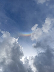 A beautiful rainbow in the sky between the clouds. A beautiful view of the rainbow