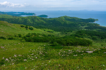 Fototapeta na wymiar Rocks on top of a hill, summer sea background.