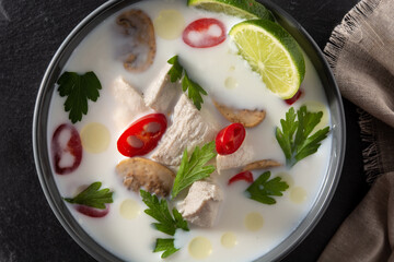 Traditional Thai food Tom Kha Gai in bowl. Top view