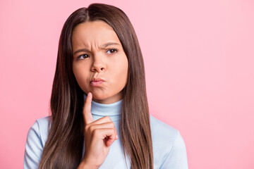 Close up portrait of thoughtful bad mood school girl dislike wear blue turtleneck isolated on pink...