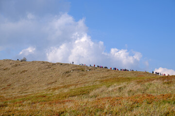 Tourists treking to Polonina Wetlinska. Bieszczady Mountains landscape.