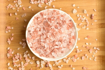Himalayan salt, close-up, on a wooden table.
