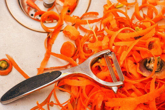 Peeler And Carrot Peels In Kitchen Sink