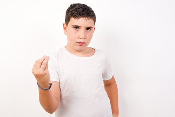 What the hell are you talking about. Shot of frustrated Caucasian young boy standing again gesturing with raised hand doing Italian gesture, frowning, being displeased and confused with dumb question.