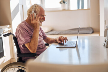 Disabled man working on his portable computer