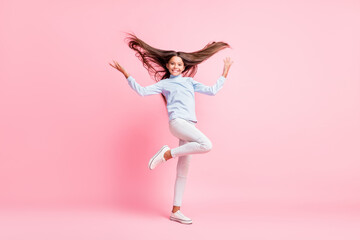 Fototapeta premium Full length body size view of charming cheerful girl throwing hair having fun isolated over pink pastel color background