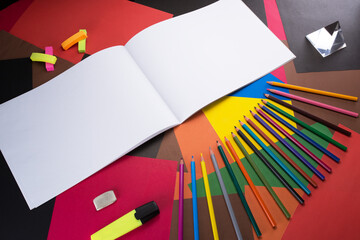 graceful and beautiful colored pencils on a multi-colored table