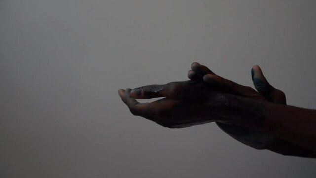 Black man with painted hands