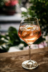 rose wine spritzer with orange cocktail drink on table outside - 390384845