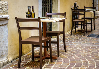 table and chairs at a sidewalk restaurant