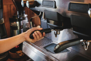 Fototapeta na wymiar Barista prepares to make coffee with a coffee machine.