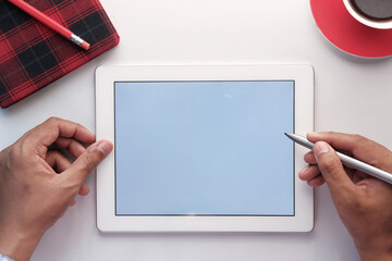 top view of digital tablet with office suppliers on table 