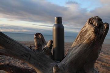 Silver water Bottle. Baltic sea in Jurkalne, Latvia. Beautiful nature landscape. Walking on the beach. Strain.