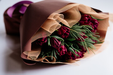 Bouquet of flowers in burgundy package