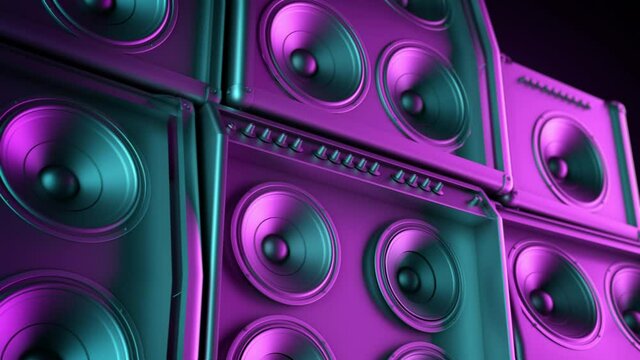Speakers tower playing in closeup, membranes vibrating lit by colorful retro neon club lights. subwoofer and speakers stacked playing music.