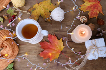 beverage, hot drink in a mug, leaves, foliage, garland, candles, top view of wooden table, good...