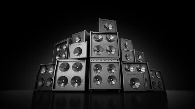 Speakers stacked in large group, many subwoofer membranes vibrating playing loud music.