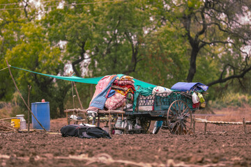 indian poor family indian poor family at agriculture field house on street