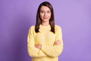 Obraz premium Photo portrait of young cute nice female brunette smiling with crossed hands wearing knitted sweater isolated on vibrant violet color background
