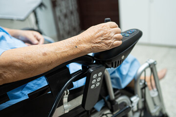 Asian senior or elderly old lady woman patient on electric wheelchair with remote control at nursing hospital ward, healthy strong medical concept