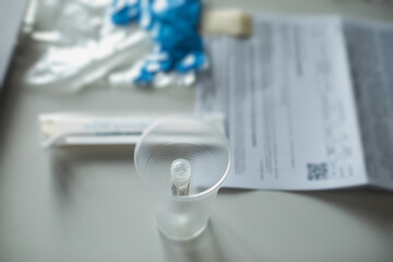 Obraz na płótnie Canvas Process of coronavirus testing examination at home, COVID-19 swab collection kit, test tube for taking OP NP patient specimen sample, testing carried out, patient receiving a corona test