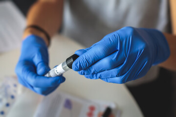Process of coronavirus testing examination at home, COVID-19 swab collection kit, test tube for taking OP NP patient specimen sample, testing carried out, patient receiving a corona test