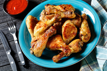 Spicy chicken drumsticks with ketchup and mustard