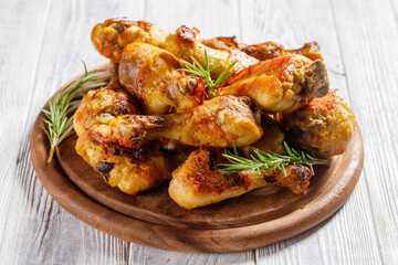 Chicken drumsticks on a wooden cutting board