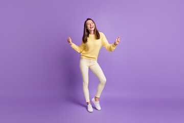 Fototapeta na wymiar Photo portrait full body view of young woman dancing isolated on vivid purple colored background