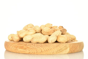 Unpeeled organic peanuts, close-up, on a white background.
