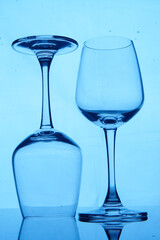 Two drinking glasses on a blue background                               