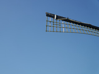 Blade of an old windmill in blue dutch sky