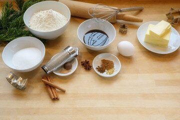 Ingredients for baking Christmas gingerbread cookies on a bright wooden worktop in the kitchen, copy space, selected focus