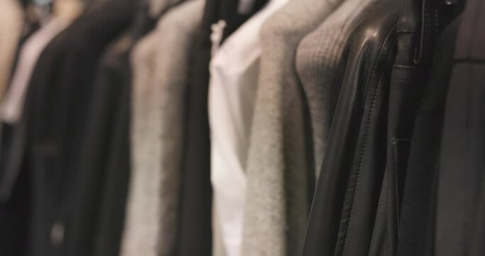 clothes rail with stylishly fashionable clothes in a minimalist fashion label in 4k