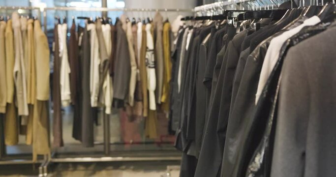 clothes rail with stylishly fashionable clothes in a minimalist fashion label in 4k